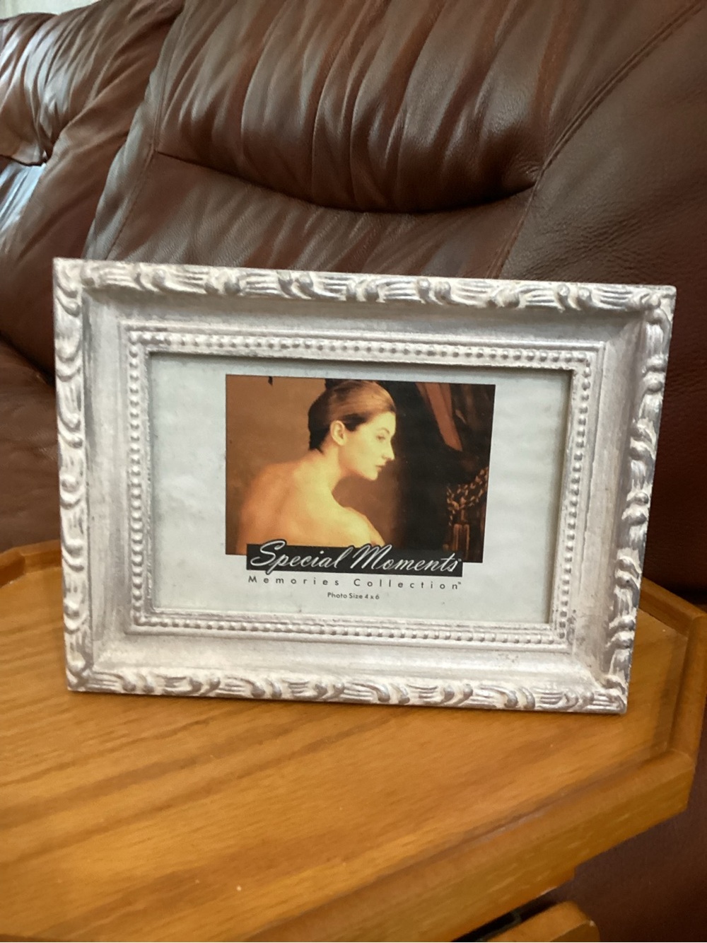 Special Moments White Distressed Ornate Frame holds a 4x6